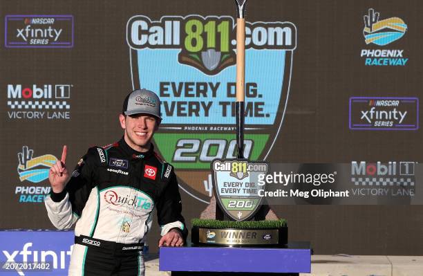 Chandler Smith, driver of the QuickTie Toyota, celebrates in victory lane after winning the NASCAR Xfinity Series Call 811.com Every Dig. Every Time....