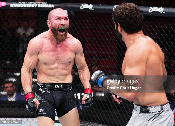 Ion Cutelaba of Moldova screams at opponent Philipe Lins of Brazil in a light heavyweight fight during the UFC 299 event at Kaseya Center on March...