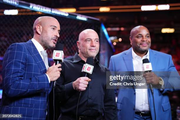 Jon Anik, Joe Rogan, and Daniel Cormier anchor the broadcast during the UFC 299 event at Kaseya Center on March 09, 2024 in Miami, Florida.