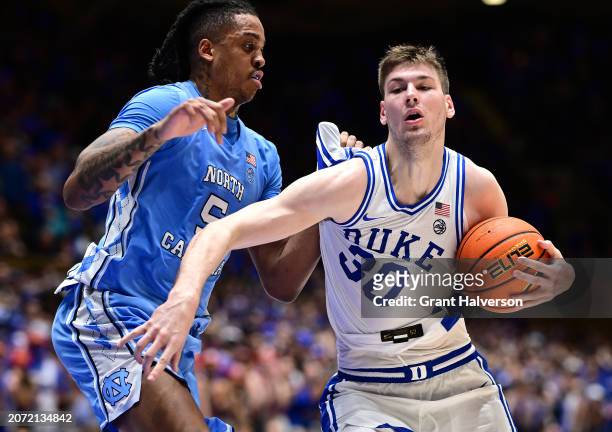 Armando Bacot of the North Carolina Tar Heels defends Kyle Filipowski of the Duke Blue Devils during the second half of the game at Cameron Indoor...
