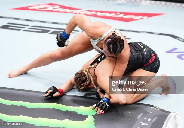 Maycee Barber punches Katlyn Cerminara in a flyweight fight during the UFC 299 event at Kaseya Center on March 09, 2024 in Miami, Florida.