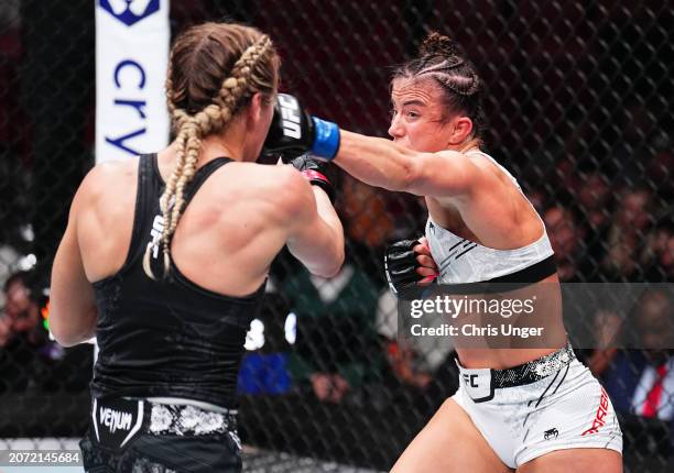 Maycee Barber punches Katlyn Cerminara in a flyweight fight during the UFC 299 event at Kaseya Center on March 09, 2024 in Miami, Florida.