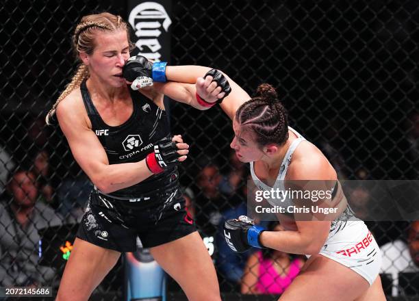 Maycee Barber punches Katlyn Cerminara in a flyweight fight during the UFC 299 event at Kaseya Center on March 09, 2024 in Miami, Florida.