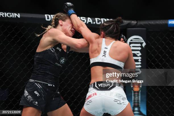 Maycee Barber punches Katlyn Cerminara during their women's flyweight bout at UFC 299 at Kaseya Center on March 09, 2024 in Miami, Florida.