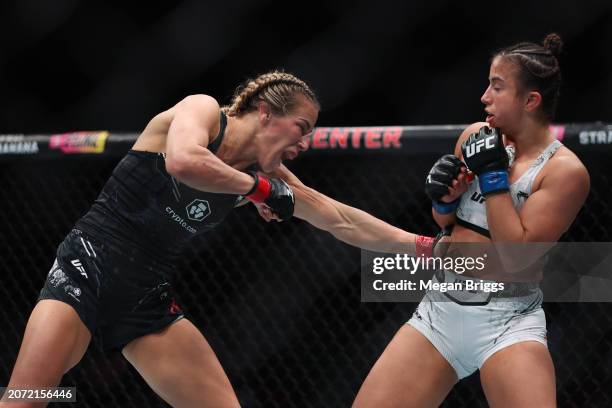 Katlyn Cerminara punches Maycee Barber during their women's flyweight bout at UFC 299 at Kaseya Center on March 09, 2024 in Miami, Florida.