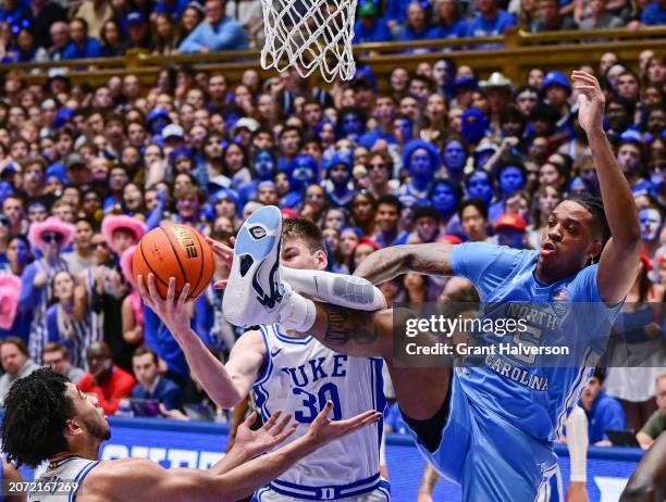 Kyle Filipowski of the Duke Blue Devils battles Armando Bacot of the North Carolina Tar Heels for a rebound during the game at Cameron Indoor Stadium...