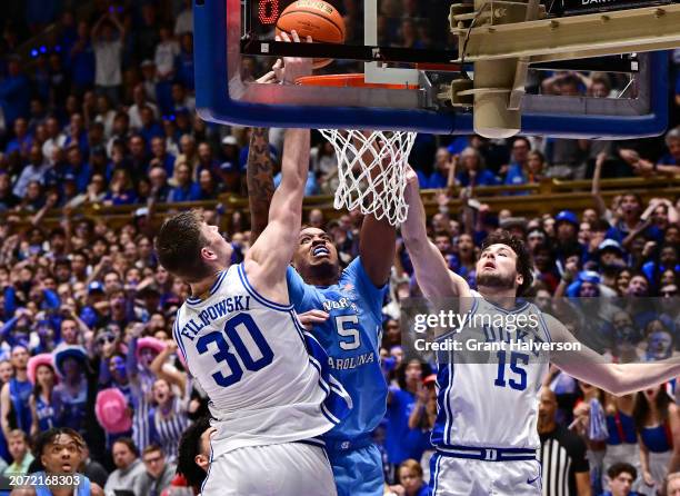 Kyle Filipowski of the Duke Blue Devils blocks a shot by Armando Bacot of the North Carolina Tar Heels during the second half of the game at Cameron...