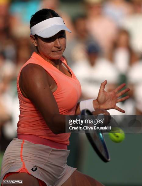 Caroline Dolehide of the United States plays a forehand against Victoria Azarenka in their second round match during the BNP Paribas Open at Indian...