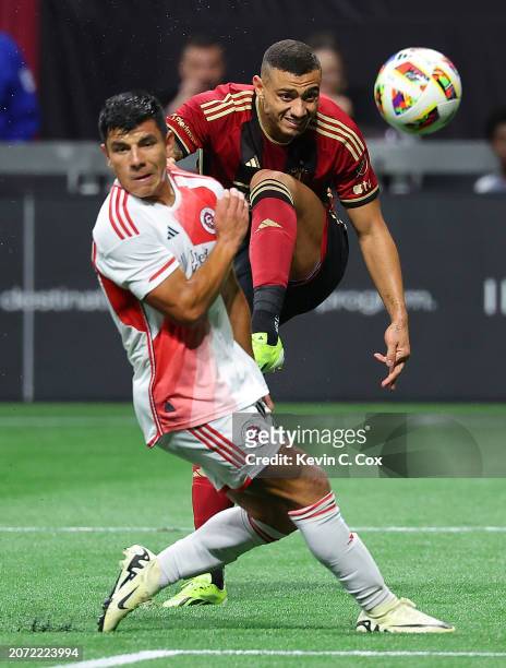 Giorgos Giakoumakis of Atlanta United scores his hat trick in the match against Nick Lima of the New England Revolution during the second half at...