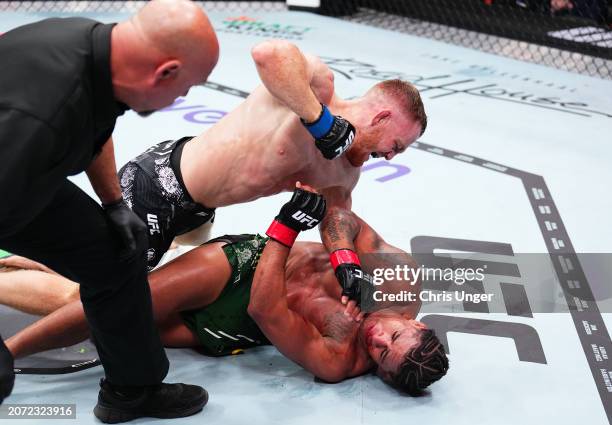 Jack Della Maddalena of Australia elbows Gilbert Burns of Brazil in a welterweight fight during the UFC 299 event at Kaseya Center on March 09, 2024...