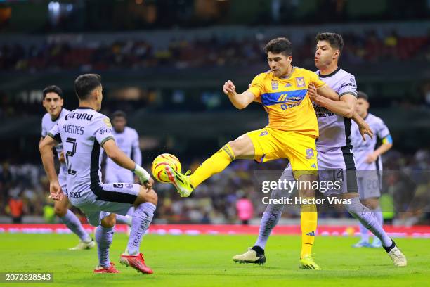 Nicolás Ibáñez of Tigres battles for possession with Nestor Araujo of America during the 11th round match between America and Tigres UANL as part of...