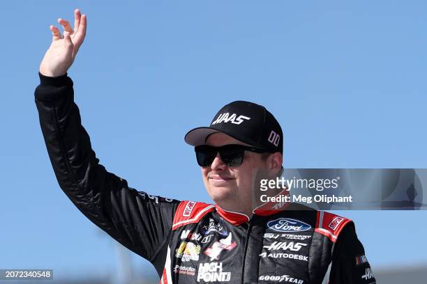 Cole Custer, driver of the Haas Automation Ford, waves to fans as he walks onstage during driver intros prior to the NASCAR Xfinity Series Call...