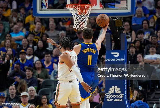 Klay Thompson of the Golden State Warriors goes in for a layup in front of Tre Jones of the San Antonio Spurs during the second half at Chase Center...