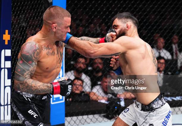 Dustin Poirier punches Benoit Saint Denis of France in a lightweight fight during the UFC 299 event at Kaseya Center on March 09, 2024 in Miami,...