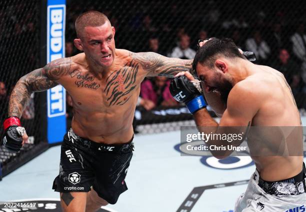 Dustin Poirier punches Benoit Saint Denis of France in a lightweight fight during the UFC 299 event at Kaseya Center on March 09, 2024 in Miami,...