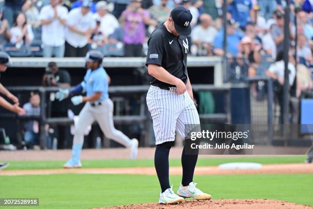 Carlos Rodon of the New York Yankees reacts as Richie Palacios of the Tampa Bay Rays runs the bases after hitting a two-run home run in the fourth...