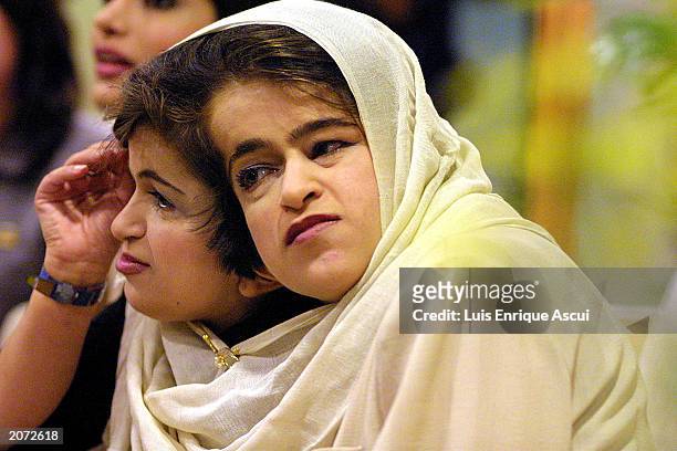 Conjoined twins Ladan and Laleh Bijani speak during a news conference at Raffles Hospital June 11, 2003 in Singapore. The Iranian sisters arrived in...