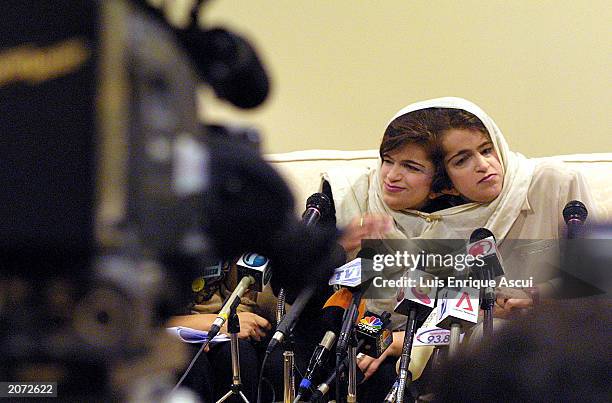 Conjoined twins Ladan and Laleh Bijani speak during a news conference at Raffles Hospital June 11, 2003 in Singapore. The Iranian sisters arrived in...