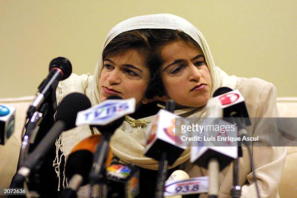 Conjoined twins Ladan and Laleh Bijani speak during a news conference at Raffles Hospital June 11, 2003 in Singapore. The Iranian sisters arrived in...