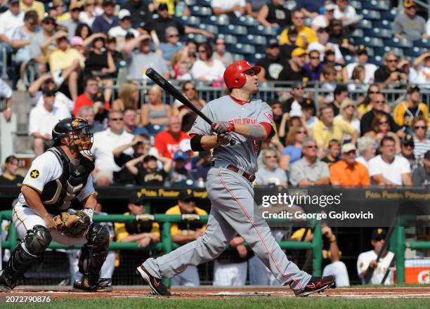 Joey Votto of the Cincinnati Reds bats as catcher Michael McKenry of the Pittsburgh Pirates looks on during a game at PNC Park on September 25, 2011...