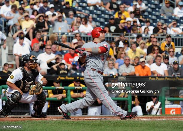 Joey Votto of the Cincinnati Reds bats as catcher Michael McKenry of the Pittsburgh Pirates looks on during a game at PNC Park on September 25, 2011...