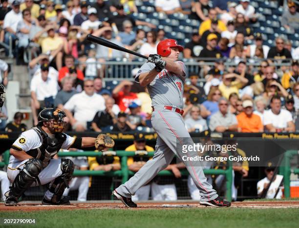Jay Bruce of the Cincinnati Reds bats as catcher Michael McKenry of the Pittsburgh Pirates looks on during a game at PNC Park on September 25, 2011...