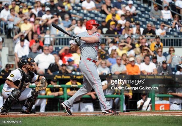 Jay Bruce of the Cincinnati Reds bats as catcher Michael McKenry of the Pittsburgh Pirates looks on during a game at PNC Park on September 25, 2011...