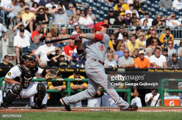 Joey Votto of the Cincinnati Reds bats as catcher Michael McKenry of the Pittsburgh Pirates looks on during a game at PNC Park on September 25, 2011...