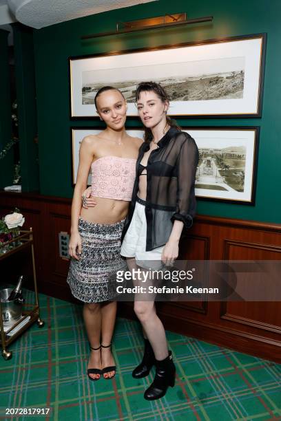 Lily-Rose Depp and Kristen Stewart attend the CHANEL and Charles Finch Annual Pre-Oscar Dinner at The Polo Lounge at The Beverly Hills Hotel on March...