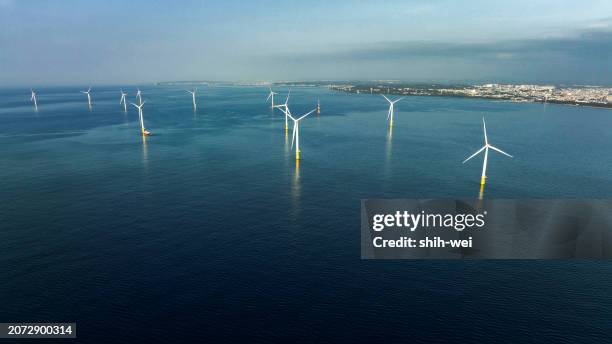 an offshore wind power installation stands majestically in the sea, with rows of turbines harnessing the power of the wind to generate renewable energy. - offshore wind turbine installation stock pictures, royalty-free photos & images