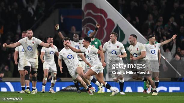 Marcus Smith of England celebrates scoring the winning drop goal as teammates celebrate behind during during the Guinness Six Nations 2024 match...