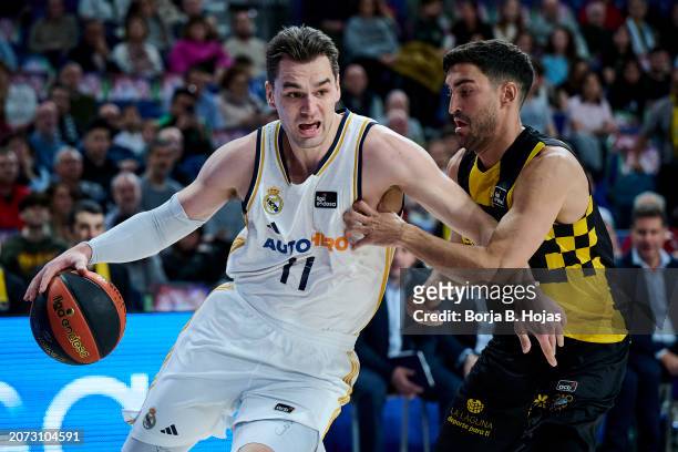 Mario Hezonja of Real Madrid and Jaime Fernandez of Lenovo Tenerife in action during Liga ACB match between Real Madrid and Lenovo Tenerife at WiZink...