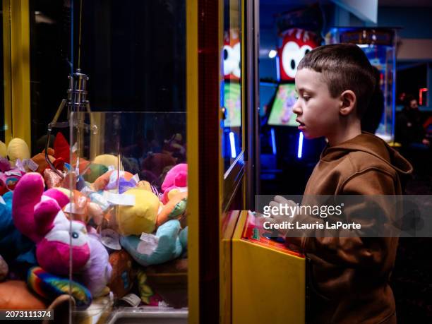 the claw game - stuffed toy stock pictures, royalty-free photos & images
