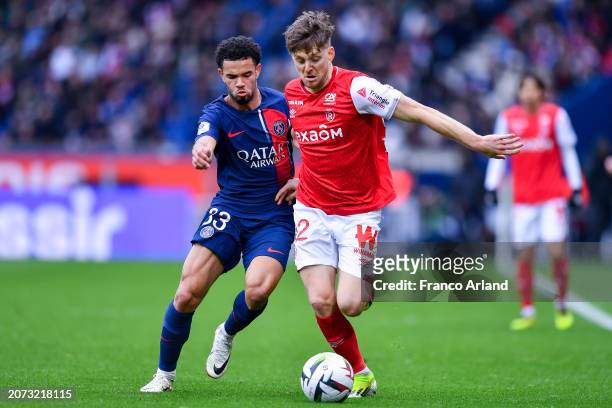 Thomas Foket of Stade de Reims competes for the ball with Warren Zaire Emery of PSG during the Ligue 1 Uber Eats match between Paris Saint-Germain...