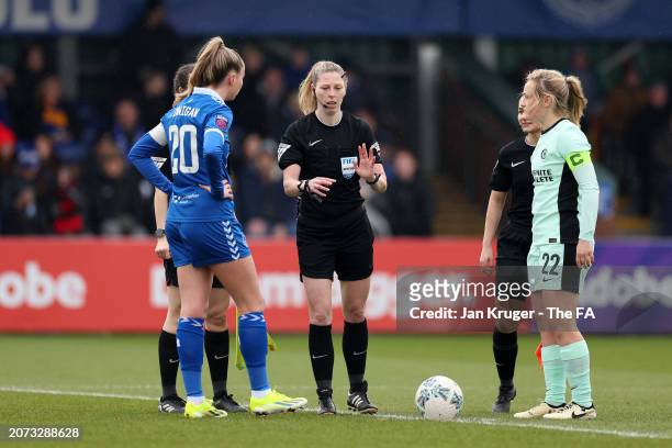 Referee Abigail Byrne performs the coin toss besides captains Megan Finnigan of Everton and Erin Cuthbert of Chelsea prior to kick-off ahead of the...