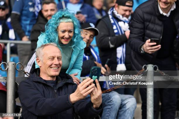 Christian Streich, Head Coach of SC Freiburg, poses for a photo with a fan prior to the Bundesliga match between VfL Bochum 1848 and Sport-Club...