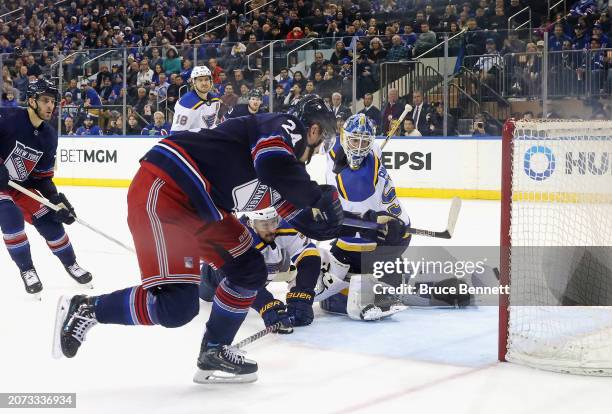 Kaapo Kakko of the New York Rangers scores a third period goal against Jordan Binnington of the St. Louis Blues at Madison Square Garden on March 09,...