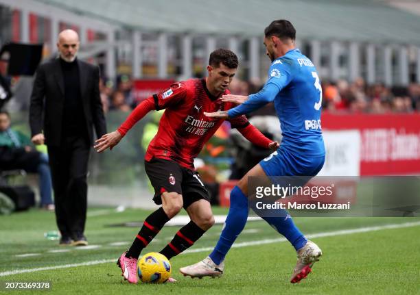 Christian Pulisic of AC Milan on the ball whilst under pressure from Giuseppe Pezzella of Empoli FC during the Serie A TIM match between AC Milan and...