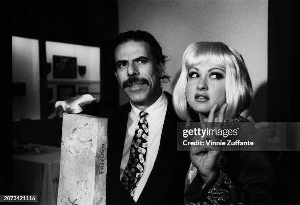 German-born American artist Peter Max and American singer, songwriter and actress Cyndi Lauper attend a 'The Wall' concert video screening, aboard...