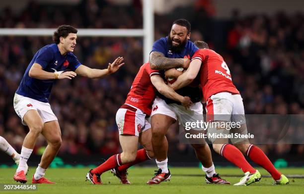 Uini Atonio of France is tackled by Will Rowlands and Tomos Williams of Wales during the Guinness Six Nations 2024 match between Wales and France at...