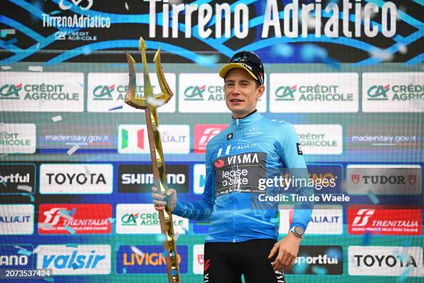 Jonas Vingegaard Hansen of Denmark and Team Visma-Lease A Bike celebrates at podium as race winner and Blue Leader Jersey with Trident Race Trophy...