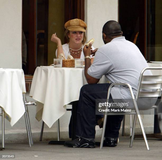 Singer Britney Spears eats lunch with some unidentified friends in SoHo June 11, 2003 in New York City.