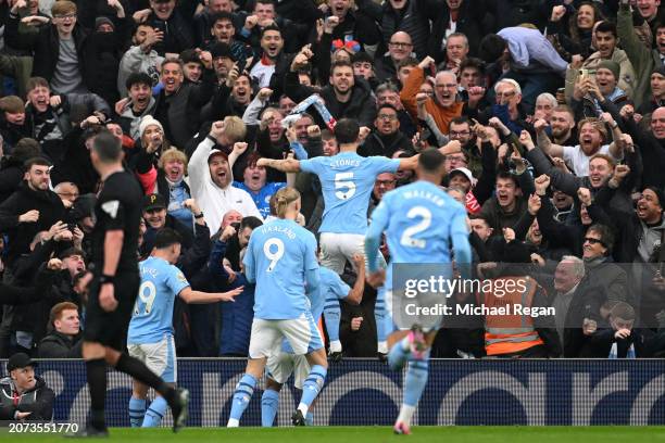 John Stones of Manchester City celebrates scoring his team's first goal with the fans during the Premier League match between Liverpool FC and...