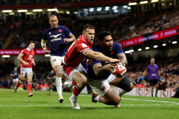 Romain Taofifenua of France scores his team's fourth try whilst under pressure from Gareth Davies of Wales for the bonus point during the Guinness...