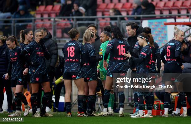 Gareth Taylor, Manager of Manchester City, speaks with his players during a drinks break in the Adobe Women's FA Cup Quarter Final match between at...