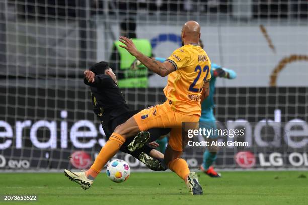 John Brooks of TSG 1899 Hoffenheim fouls Omar Marmoush of Eintracht Frankfurt which results in a red card during the Bundesliga match between...