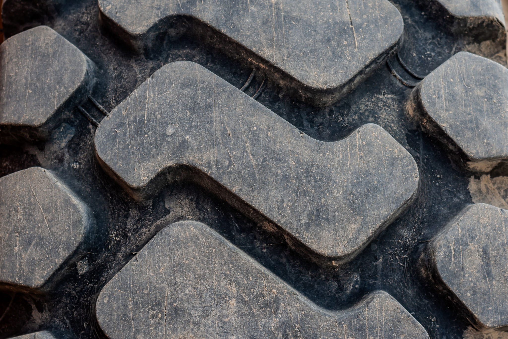 Close up of tire with an aggressive, deep wavy tread for grip Close up of tire with an aggressive, deep wavy tread for grip