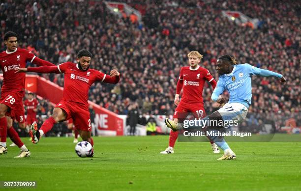 Jeremy Doku of Manchester City shoots and hits the post whilst under pressure from Joe Gomez of Liverpool during the Premier League match between...