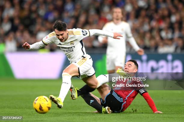 Brahim Diaz of Real Madrid is challenged by Iago Aspas of Celta Vigo during the LaLiga EA Sports match between Real Madrid CF and Celta Vigo at...