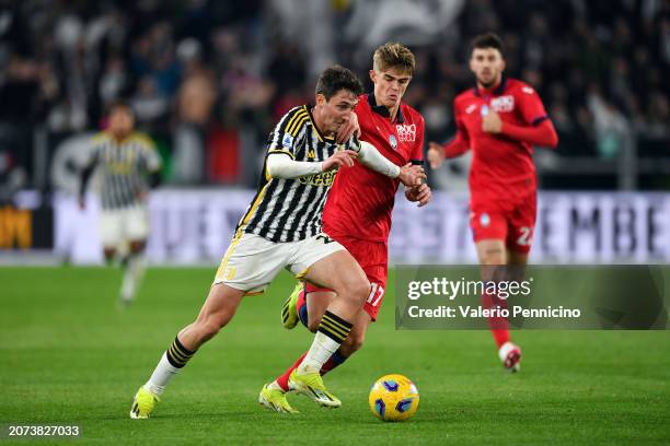 Andrea Cambiaso of Juventus runs with the ball whilst under pressure from Charles De Ketelaere of Atalanta BC during the Serie A TIM match between...